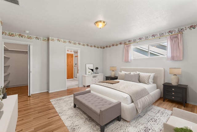 1728 S Labrador Pl, Meridian, ID 83642 - bedroom featuring light wood finished floors and a spacious closet