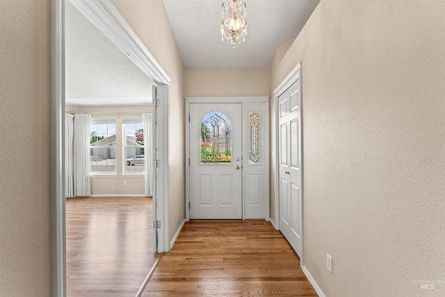 1728 S Labrador Pl, Meridian, ID 83642 - doorway with a chandelier and wood finished floors