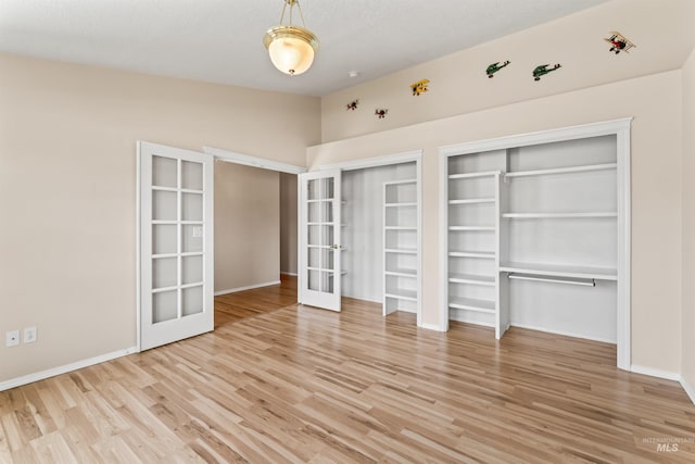 1728 S Labrador Pl, Meridian, ID 83642 - unfurnished bedroom with french doors, wood finished floors, and lofted ceiling