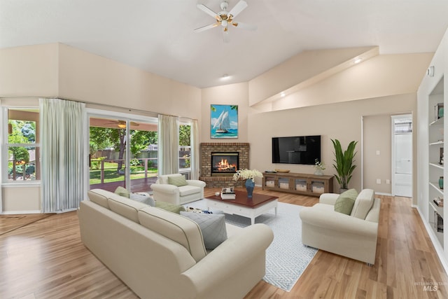 1728 S Labrador Pl, Meridian, ID 83642 - living room featuring a ceiling fan, a fireplace, wood finished floors, and high vaulted ceiling