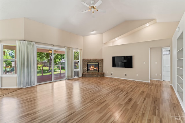 1728 S Labrador Pl, Meridian, ID 83642 - unfurnished living room featuring a ceiling fan, light wood finished floors, high vaulted ceiling, and a fireplace
