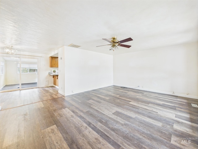 1409 Blane, Emmett, ID 83617 - unfurnished living room featuring light wood-style flooring, a chandelier, a ceiling fan, and baseboards