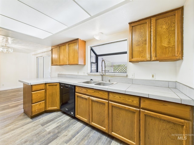 1409 Blane, Emmett, ID 83617 - kitchen with a sink, dishwasher, light wood-style flooring, a peninsula, and brown cabinetry