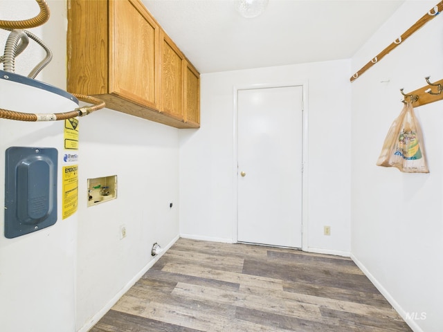 1409 Blane, Emmett, ID 83617 - laundry area featuring cabinet space, washer hookup, electric dryer hookup, wood finished floors, and baseboards
