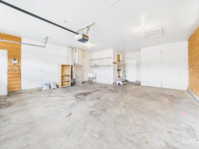 1409 Blane, Emmett, ID 83617 - garage featuring a garage door opener, wooden walls, and a sink