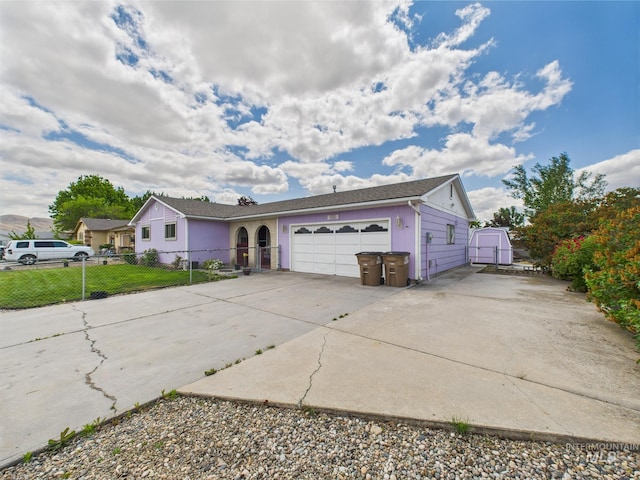 1409 Blane, Emmett, ID 83617 - ranch-style home with an attached garage, concrete driveway, and a storage shed