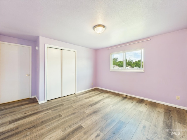 1409 Blane, Emmett, ID 83617 - unfurnished bedroom featuring baseboards, wood finished floors, and a closet