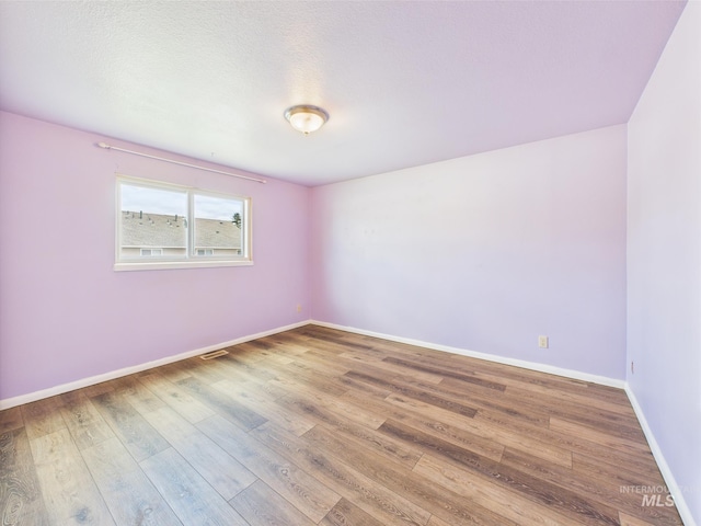 1409 Blane, Emmett, ID 83617 - spare room featuring wood finished floors and baseboards