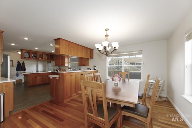 dining area with dark wood-style flooring, baseboards, a chandelier, and recessed lighting