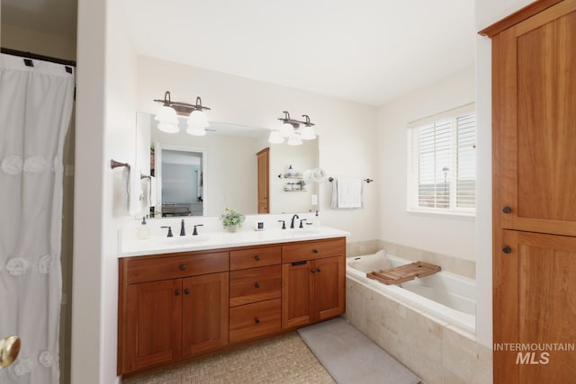 bathroom with a sink, a garden tub, and double vanity