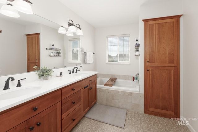 bathroom featuring a sink, tile patterned flooring, double vanity, and a bath