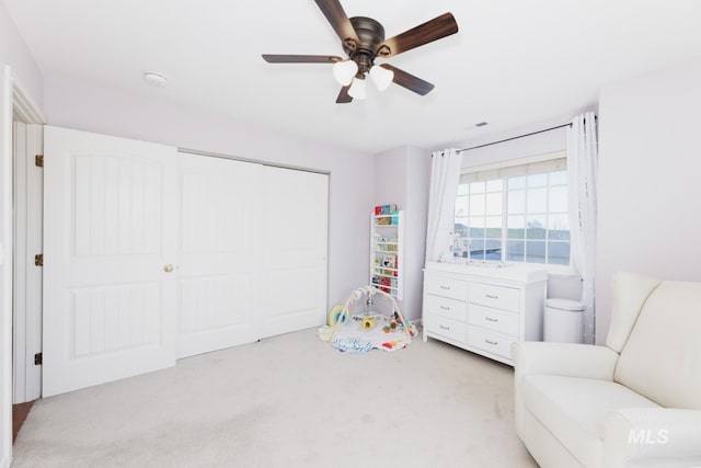interior space featuring a ceiling fan and a closet