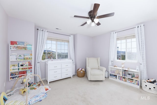 recreation room featuring carpet flooring, ceiling fan, and visible vents