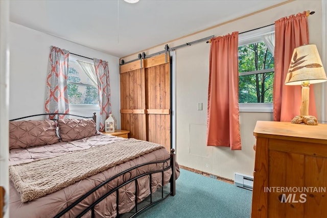 carpeted bedroom with a baseboard radiator and a barn door