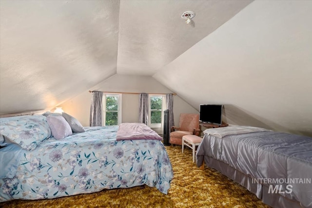 carpeted bedroom featuring vaulted ceiling