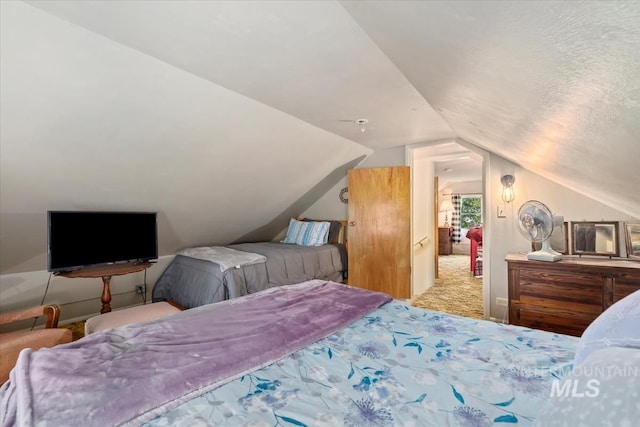 carpeted bedroom featuring lofted ceiling