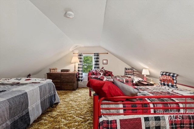 bedroom with carpet and vaulted ceiling