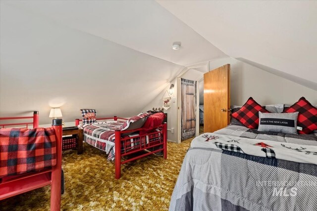 carpeted bedroom with vaulted ceiling