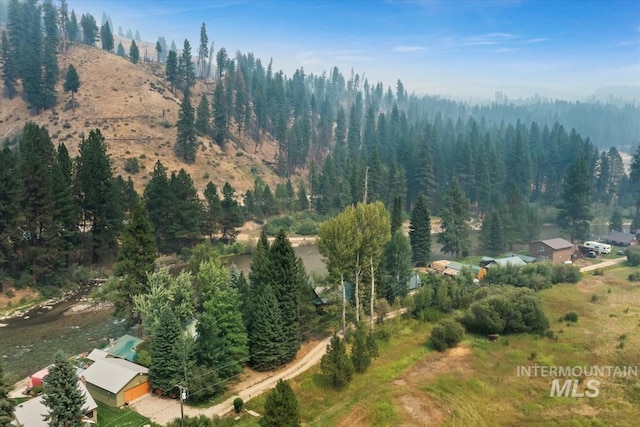 birds eye view of property with a forest view