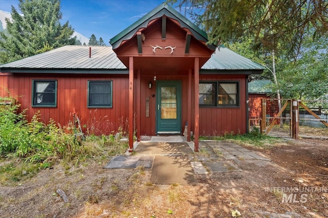 rustic home featuring metal roof and board and batten siding