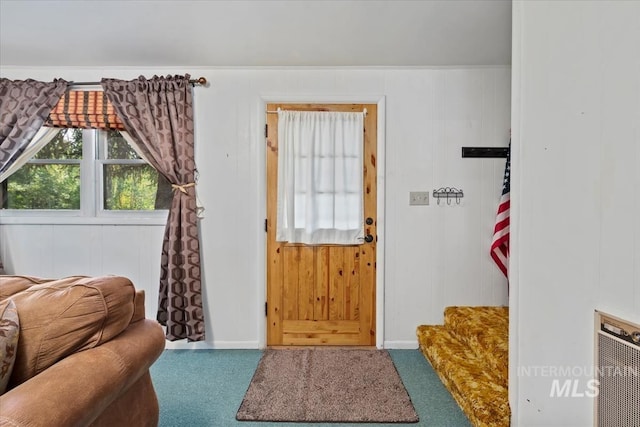 doorway to outside with carpet floors