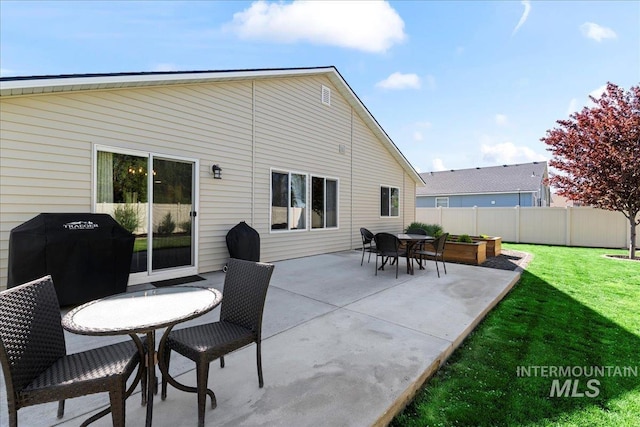 rear view of property with a patio area and outdoor dining area
