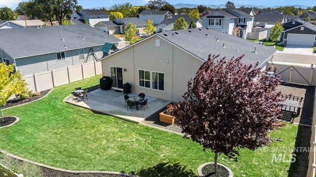 rear view of property with a residential view and a patio