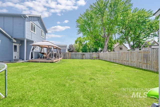 1010 Jonathan St, Fruitland, ID 83619 - fenced backyard featuring a gazebo and a wooden deck