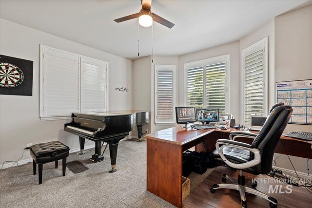 carpeted home office featuring ceiling fan and baseboards