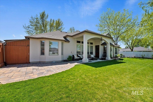 rear view of house with an outdoor living space, a patio, stucco siding, and roof with shingles