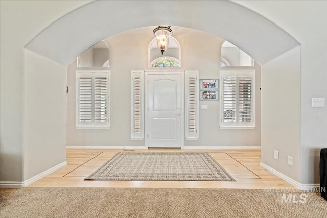 entrance foyer with baseboards and wood finished floors