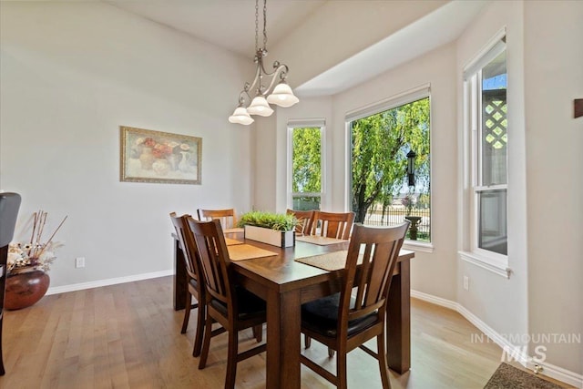 dining space with light wood finished floors and baseboards