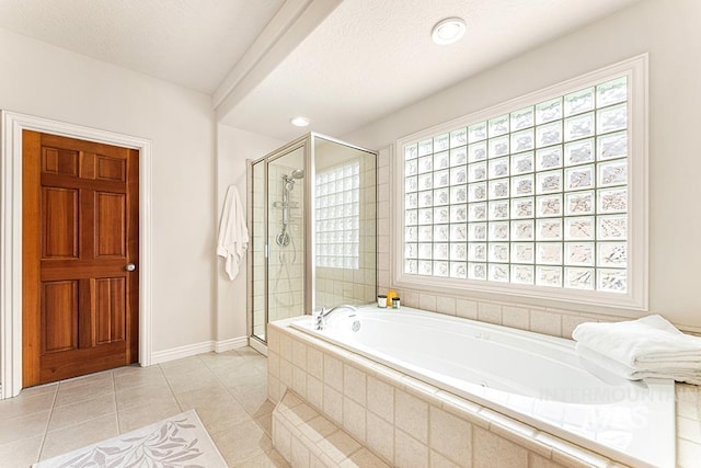 full bath with a garden tub, a stall shower, tile patterned flooring, and a textured ceiling