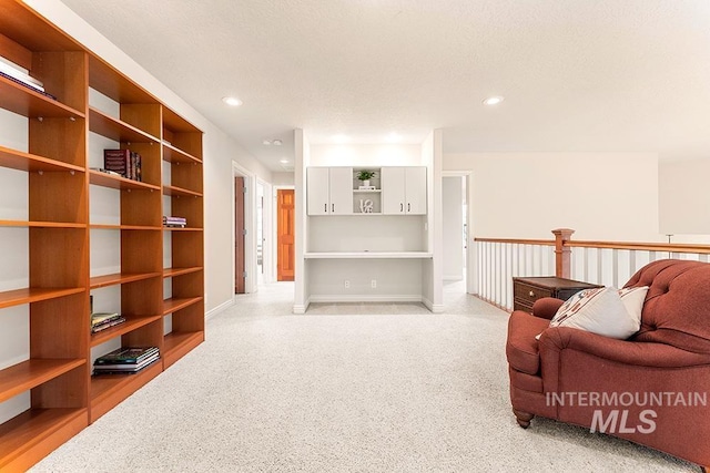 sitting room featuring baseboards and recessed lighting