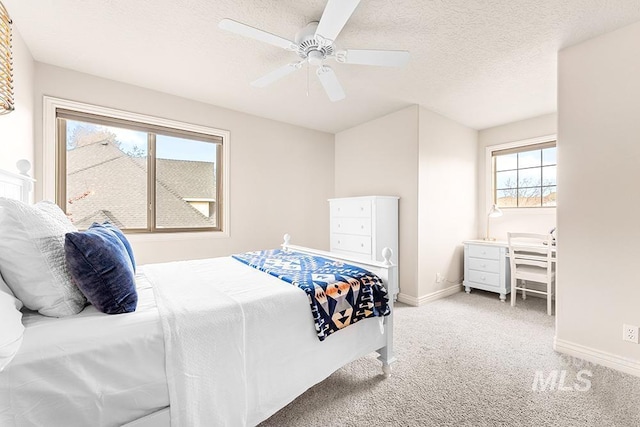 bedroom featuring a ceiling fan, a textured ceiling, baseboards, and carpet flooring