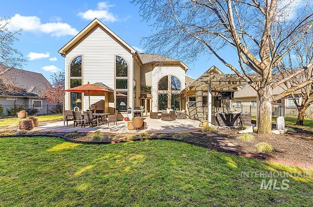 back of house featuring a patio, a lawn, fence, and a pergola