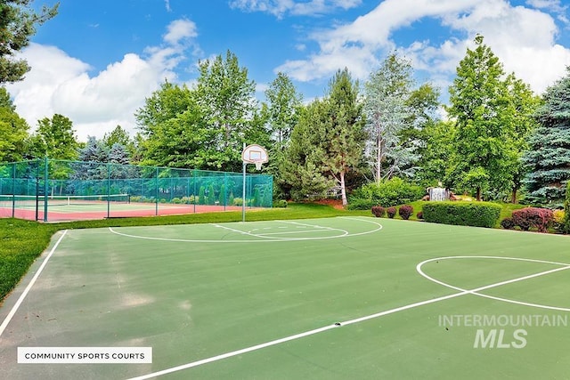 view of sport court with a tennis court, community basketball court, and fence