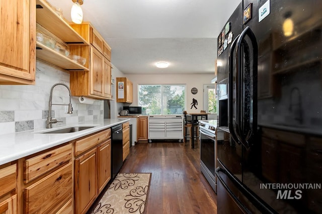 12456 S Lonnie Ln, Kuna, ID 83634 - kitchen with black appliances, a sink, tasteful backsplash, light countertops, and dark wood finished floors