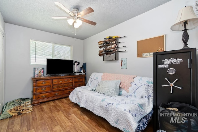 12456 S Lonnie Ln, Kuna, ID 83634 - bedroom with wood finished floors, a textured ceiling, and ceiling fan