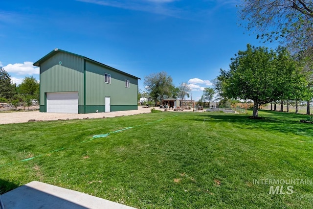 12456 S Lonnie Ln, Kuna, ID 83634 - view of grassy yard featuring an outbuilding and a garage