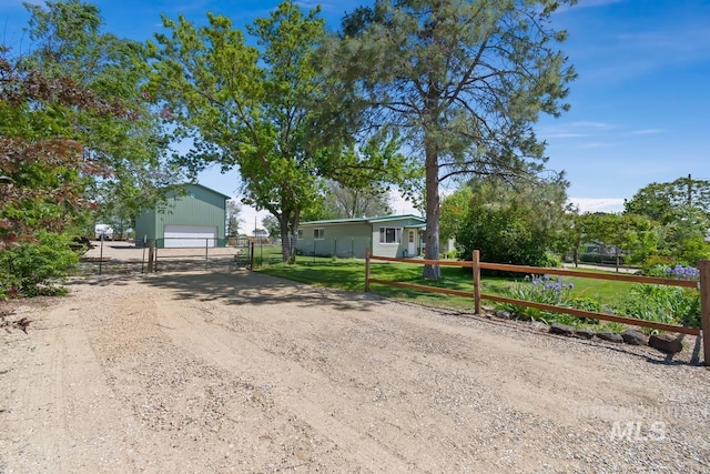 12456 S Lonnie Ln, Kuna, ID 83634 - view of front of property featuring a garage, an outdoor structure, and dirt driveway