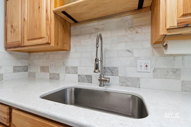 12456 S Lonnie Ln, Kuna, ID 83634 - kitchen featuring a sink, light countertops, and tasteful backsplash