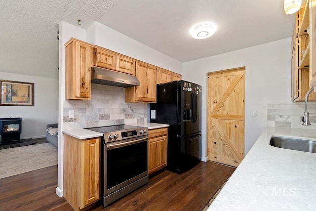 12456 S Lonnie Ln, Kuna, ID 83634 - kitchen with electric range, a sink, black fridge with ice dispenser, under cabinet range hood, and dark wood-style flooring