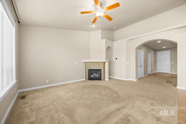 18555 N Goldenridge Pl, Boise, ID 83714 - unfurnished living room with arched walkways, ceiling fan, visible vents, and light colored carpet