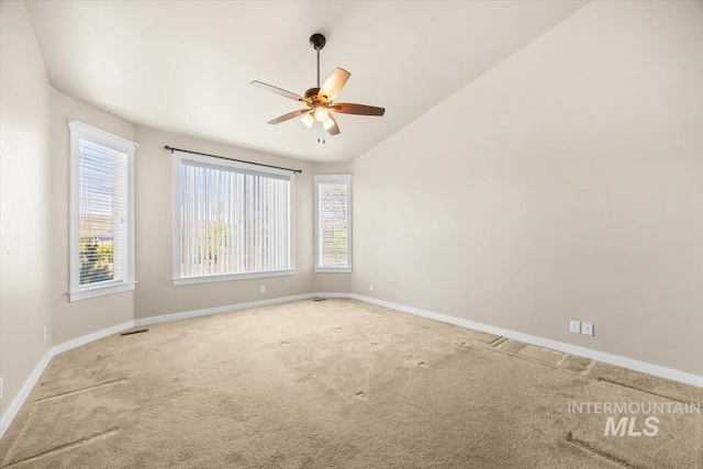 18555 N Goldenridge Pl, Boise, ID 83714 - carpeted spare room with vaulted ceiling, baseboards, visible vents, and ceiling fan