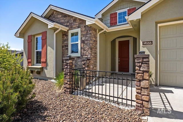 18555 N Goldenridge Pl, Boise, ID 83714 - view of exterior entry featuring stone siding, stucco siding, and a garage