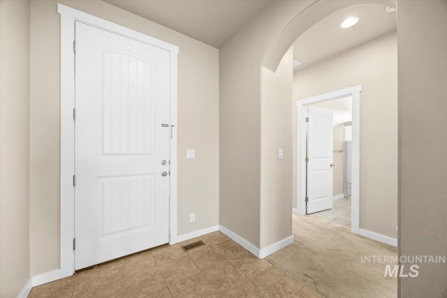 18555 N Goldenridge Pl, Boise, ID 83714 - entrance foyer with light colored carpet, visible vents, baseboards, and arched walkways