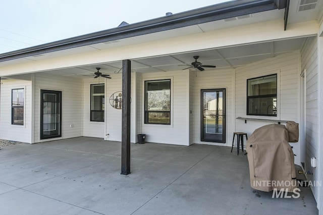 view of patio with ceiling fan and a grill