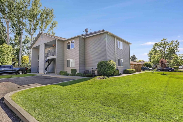 275 Elaine Ave Unit 2, Twin Falls, ID 83301 - view of side of property with a lawn, stairway, and central AC unit