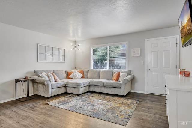 275 Elaine Ave Unit 2, Twin Falls, ID 83301 - living room featuring dark wood-style flooring, a chandelier, baseboards, and a textured ceiling